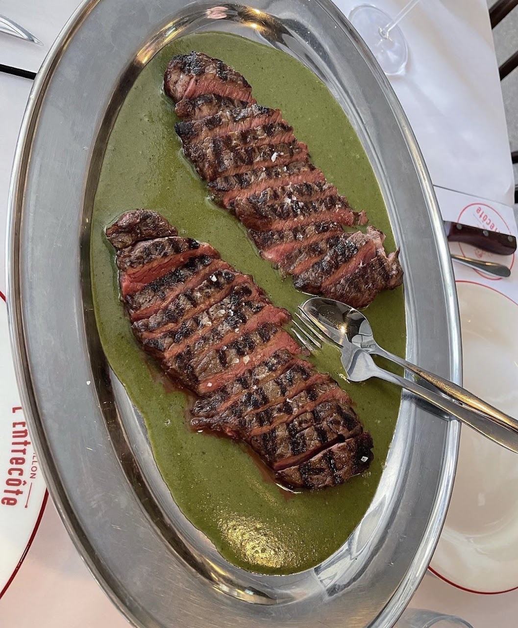 Sliced steak served with Bouillon L'Entrecôte sauce